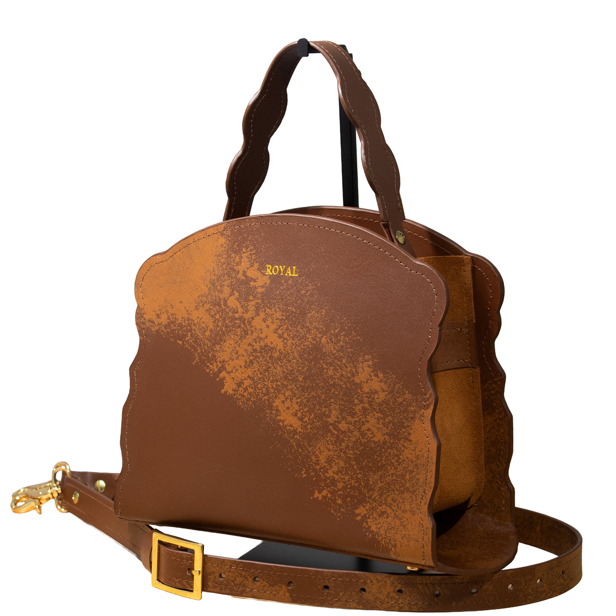 Joy full‑grain vegetable‑tanned leather handbag in brown with multi‑tone accents, shown with an architectural structured silhouette, a top handle, and a removable strap