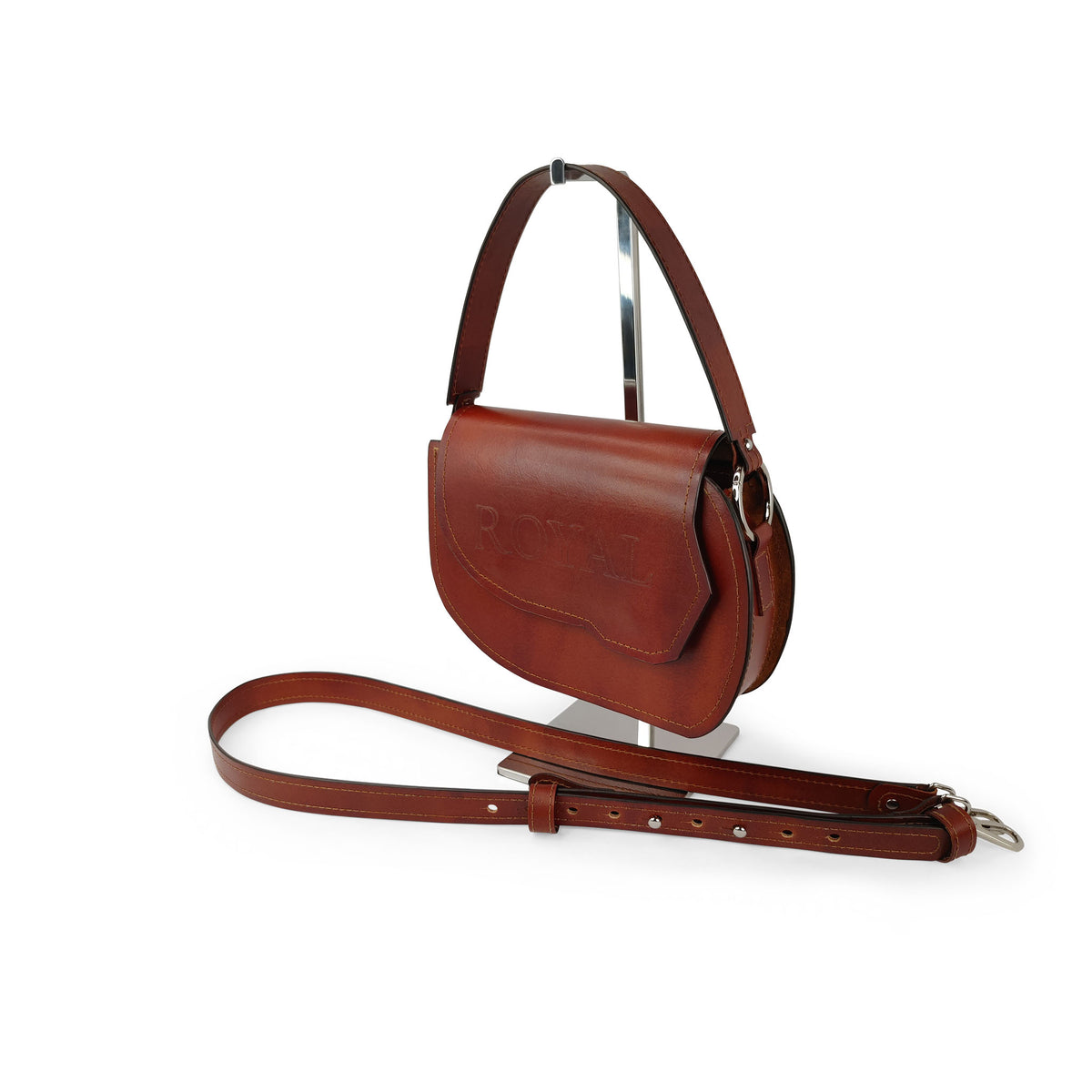 Grace full‑grain vegetable‑tanned leather top‑handle crossbody bag in brown shown closed on a stand with its structured silhouette