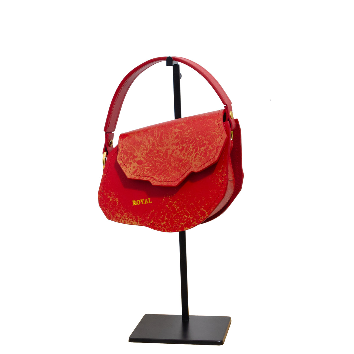 Close‑up of hand‑painted red full‑grain vegetable‑tanned leather on the Charity Mini crossbody with gold accents