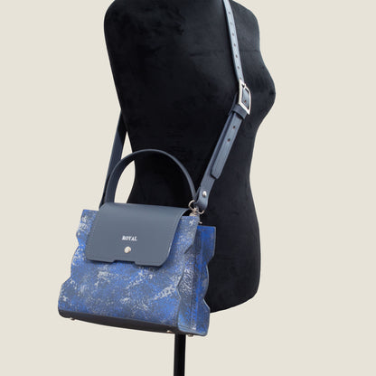 Hand‑painted full‑grain leather Bless shoulder bag satchel handcrafted in gray and blue artisan multi‑tone worn across the mannequin’s body in a bespoke design.  