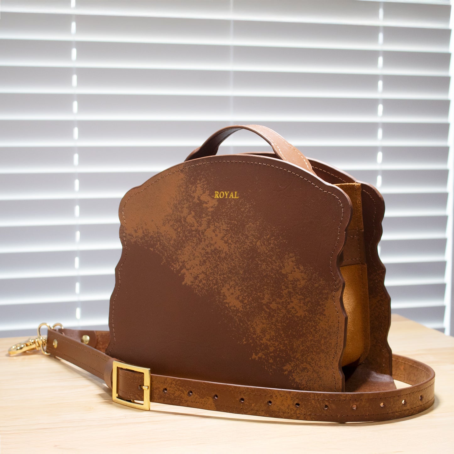 Joy luxury handcrafted satchel, lifestyle view on wooden table