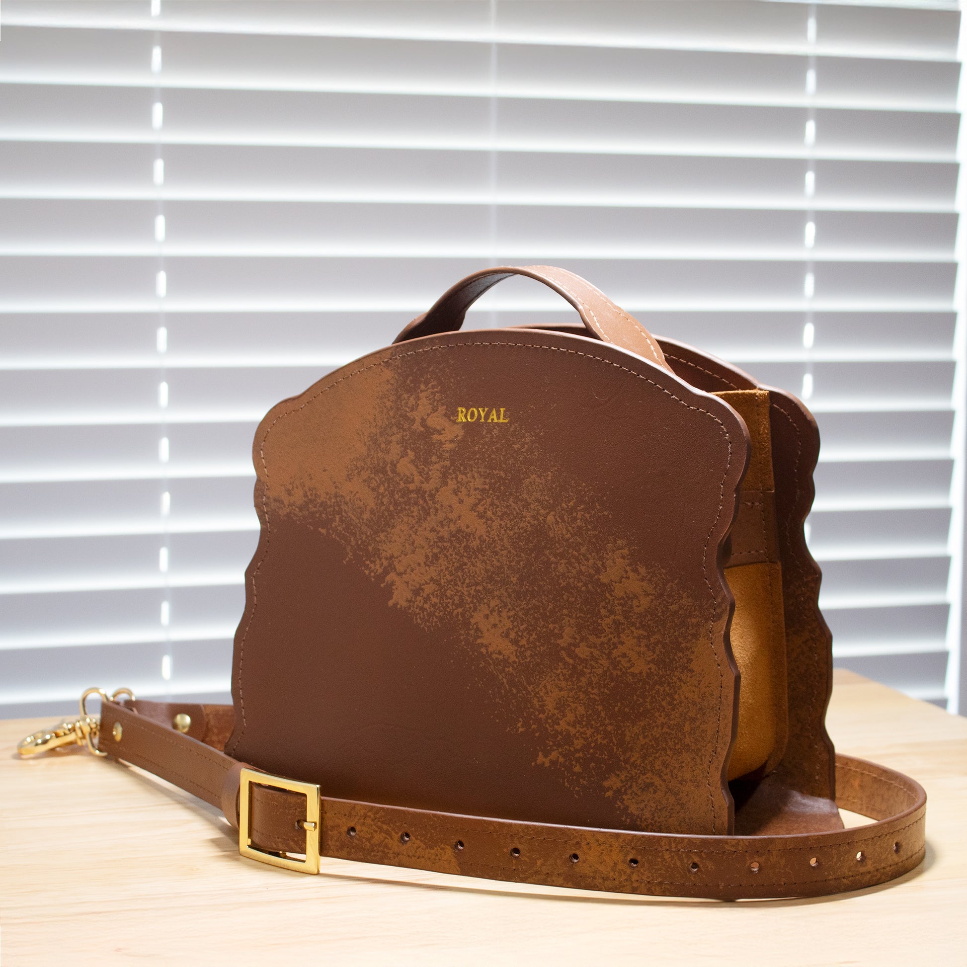 Joy luxury handcrafted satchel, lifestyle view on wooden table